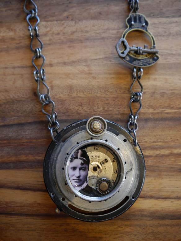 Vintage camera parts, watch face, vintage buttons, key, photograph, steel chain.